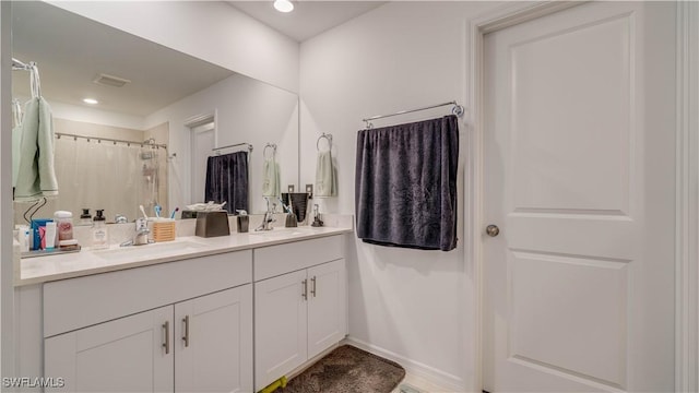 bathroom featuring vanity and curtained shower