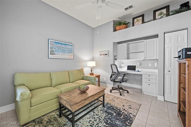 tiled office with ceiling fan and a towering ceiling