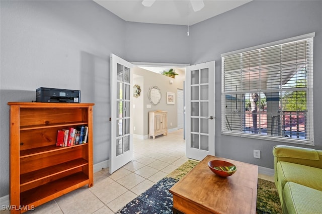 sitting room with french doors, ceiling fan, and light tile patterned flooring