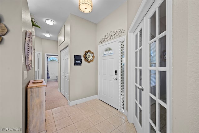 foyer entrance featuring light tile patterned flooring