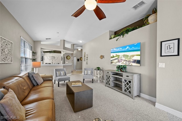 living room featuring vaulted ceiling, carpet flooring, and ceiling fan