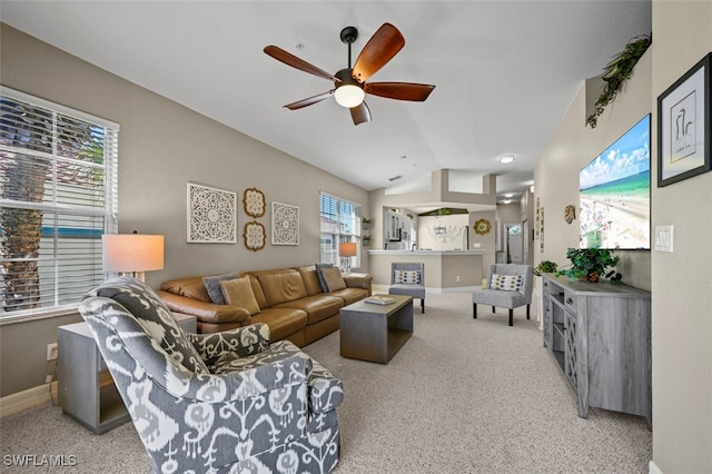 carpeted living room featuring ceiling fan, vaulted ceiling, and a healthy amount of sunlight