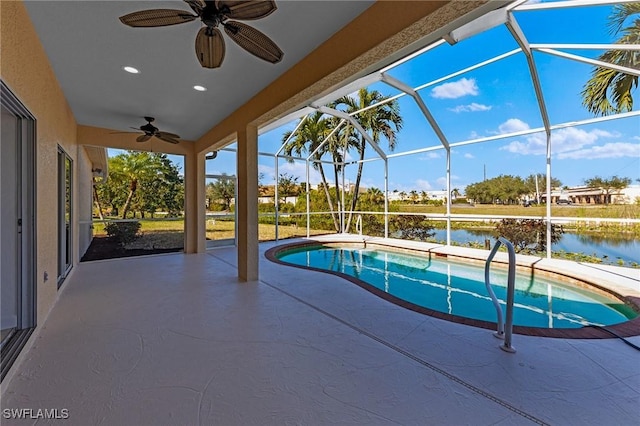 view of swimming pool featuring a water view, ceiling fan, a lanai, and a patio