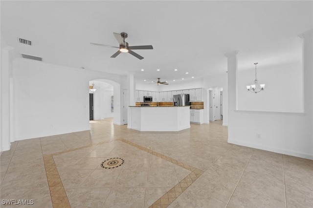 unfurnished living room featuring ceiling fan with notable chandelier and light tile patterned floors