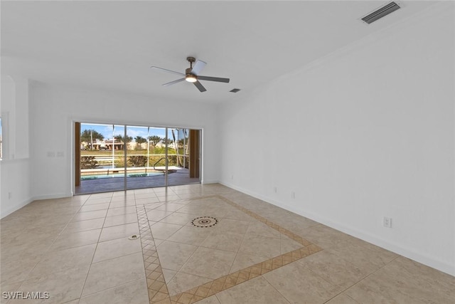 tiled spare room featuring ceiling fan