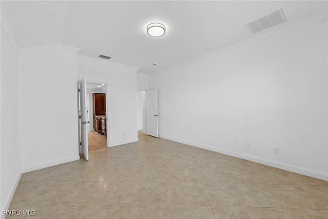 spare room featuring crown molding