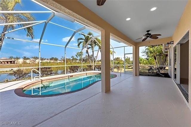 view of swimming pool with a lanai, a patio, ceiling fan, and a water view