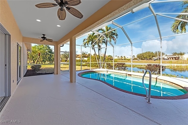 view of pool with a water view, a patio, a lanai, and ceiling fan