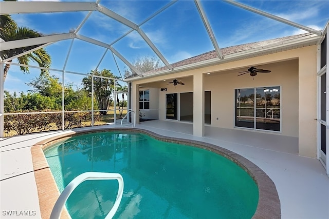 view of pool featuring ceiling fan, glass enclosure, and a patio