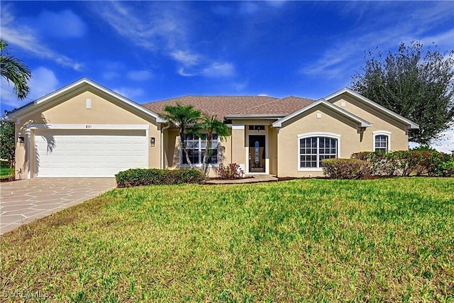 ranch-style home with a garage and a front lawn