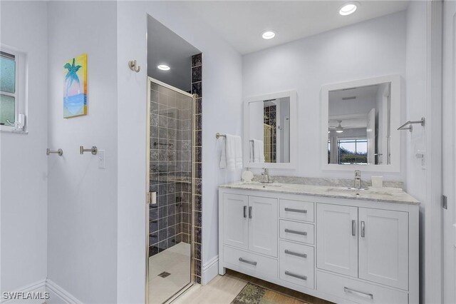 bathroom with vanity, hardwood / wood-style floors, and a shower with door