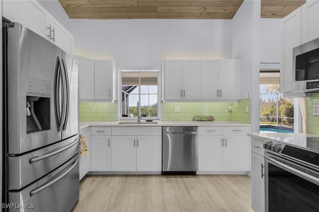 5139 Genesee Pkwy, Bokeelia, FL 33922 - kitchen featuring wooden ceiling, light countertops, a sink, and stainless steel appliances