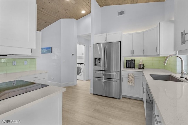 5139 Genesee Pkwy, Bokeelia, FL 33922 - kitchen with wood ceiling, a sink, washer / clothes dryer, stainless steel appliances, and visible vents