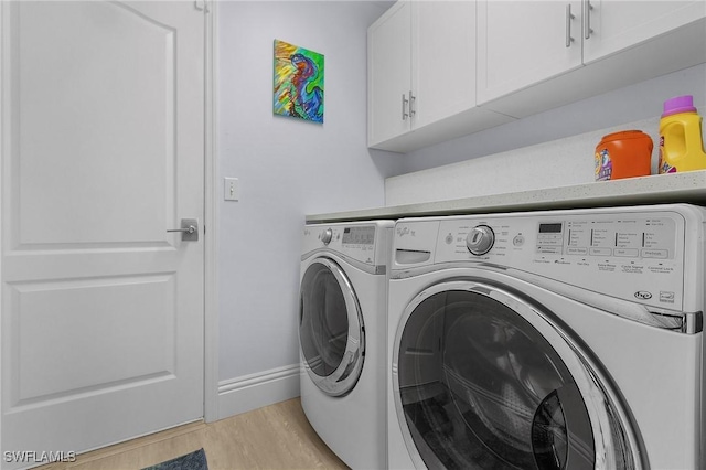 laundry room with cabinets, a mail area, independent washer and dryer, and light hardwood / wood-style flooring