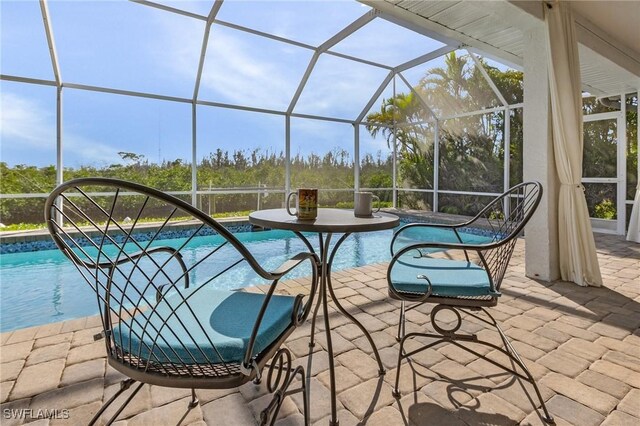 view of patio with glass enclosure