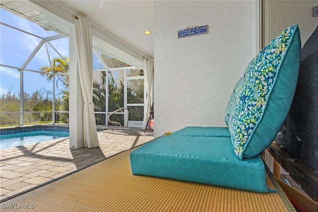5139 Genesee Pkwy, Bokeelia, FL 33922 - exterior space featuring access to exterior, floor to ceiling windows, a textured wall, a sunroom, and recessed lighting