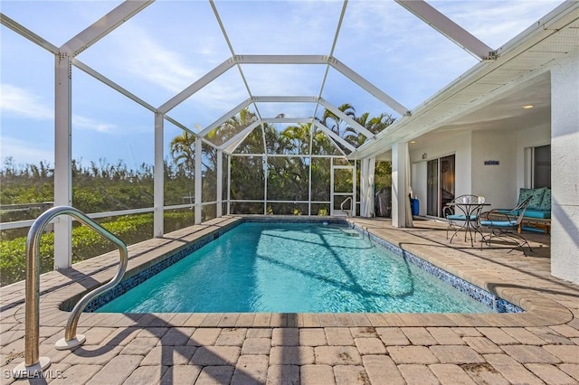 view of pool with a patio and a lanai