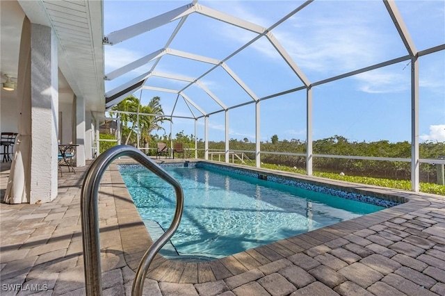 view of swimming pool with a lanai and a patio area