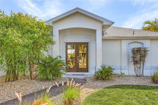 5139 Genesee Pkwy, Bokeelia, FL 33922 - doorway to property featuring stucco siding, french doors, and roof with shingles
