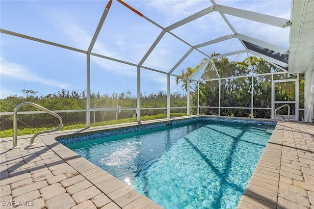 view of pool with a patio and glass enclosure