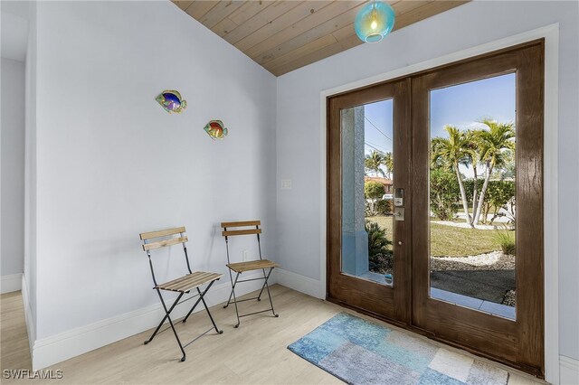 doorway featuring french doors, wood ceiling, lofted ceiling, and light wood-type flooring