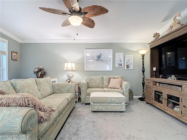 living room with ornamental molding, carpet, and ceiling fan