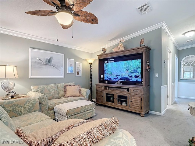 home theater featuring ornamental molding, light colored carpet, and ceiling fan