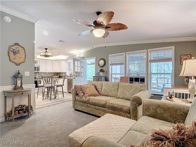 carpeted living room featuring lofted ceiling, ornamental molding, and ceiling fan