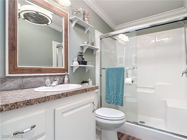 bathroom with crown molding, hardwood / wood-style flooring, a shower with door, vanity, and a textured ceiling