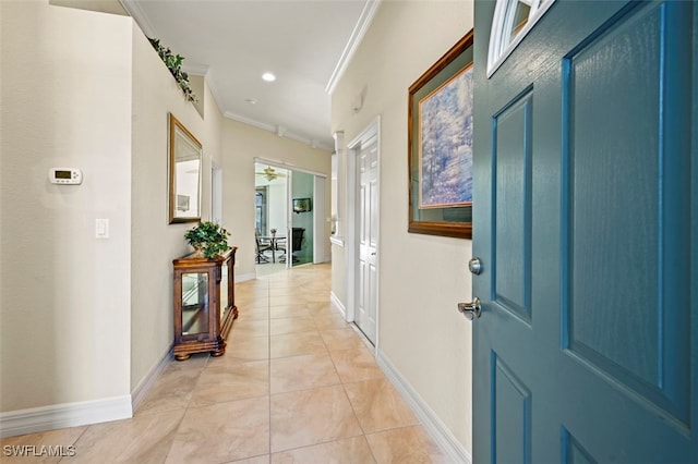 corridor featuring crown molding and light tile patterned floors