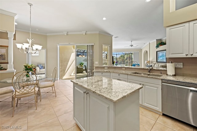 kitchen featuring a kitchen island, decorative light fixtures, white cabinetry, sink, and stainless steel dishwasher