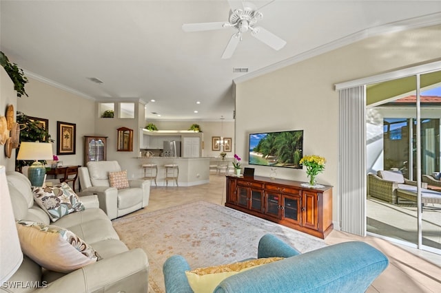 living room featuring ornamental molding, plenty of natural light, light tile patterned floors, and ceiling fan