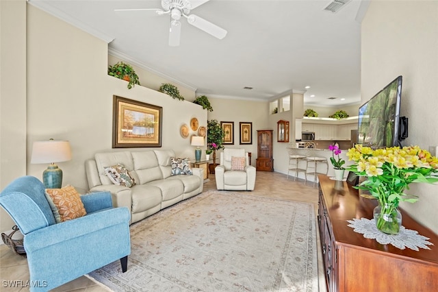 living room featuring ceiling fan, ornamental molding, and light tile patterned floors