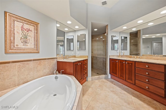 bathroom with vanity, plus walk in shower, and tile patterned flooring