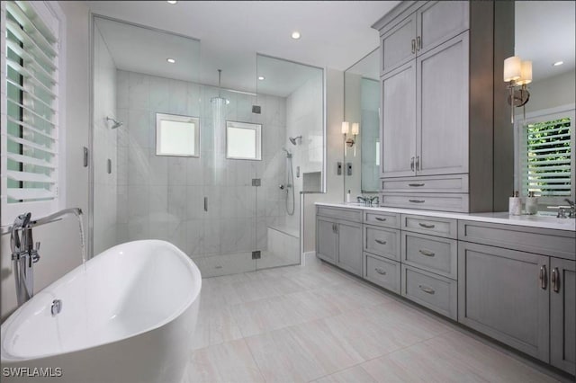 bathroom featuring vanity and shower with separate bathtub