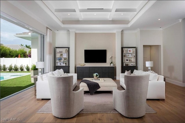 living room featuring a towering ceiling, coffered ceiling, crown molding, beam ceiling, and light hardwood / wood-style flooring