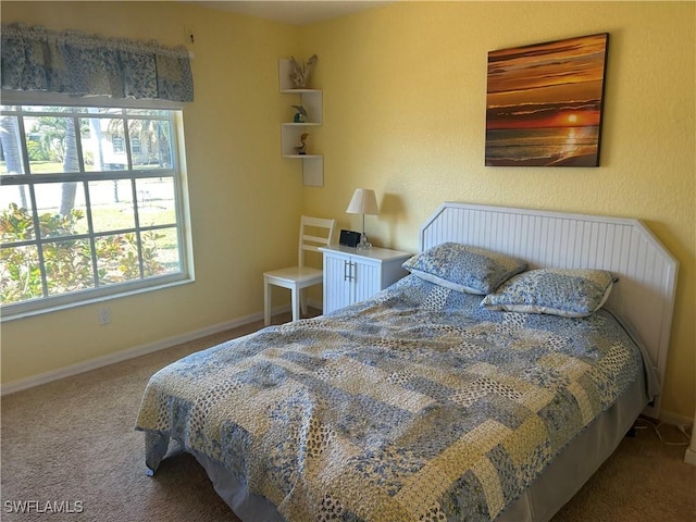 carpeted bedroom featuring baseboards