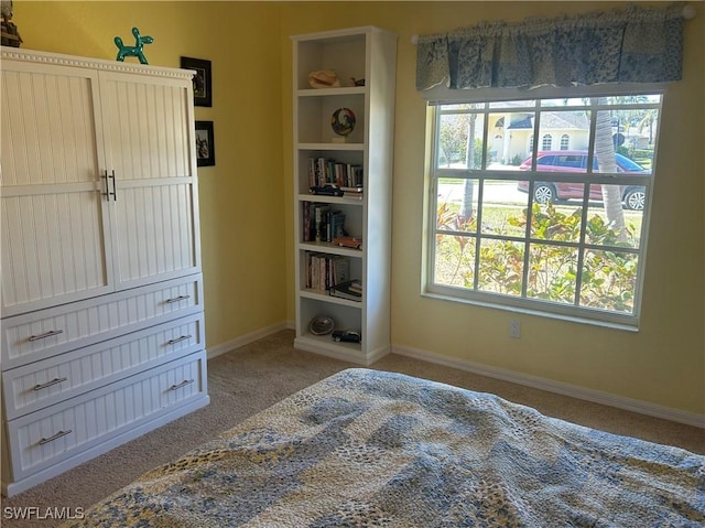 bedroom with carpet and baseboards