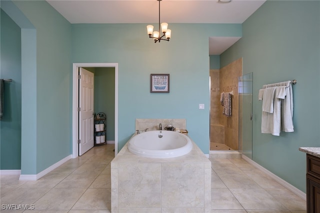 bathroom featuring tile patterned floors, vanity, plus walk in shower, and a chandelier