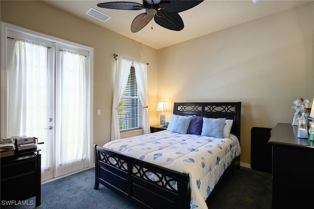 bedroom featuring ceiling fan and dark carpet