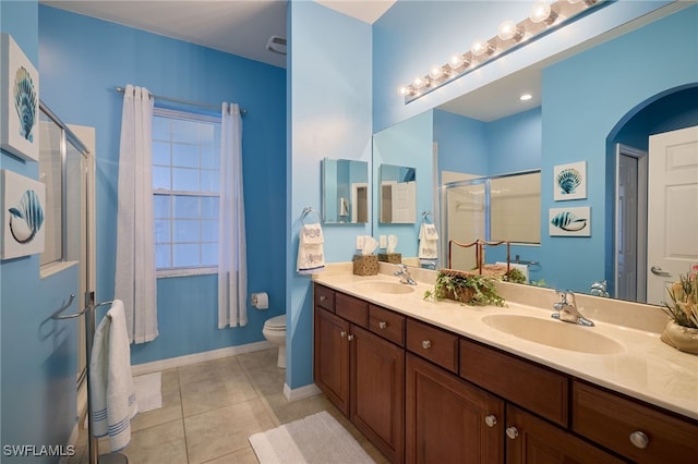 bathroom with walk in shower, tile patterned floors, toilet, and vanity