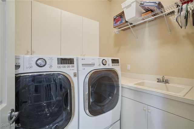 laundry area with sink, cabinets, and independent washer and dryer