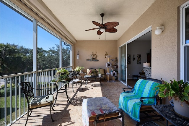 sunroom / solarium featuring ceiling fan