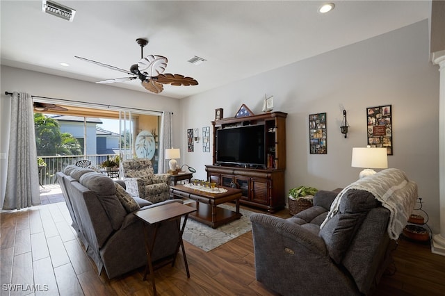 living room featuring ceiling fan and dark hardwood / wood-style floors