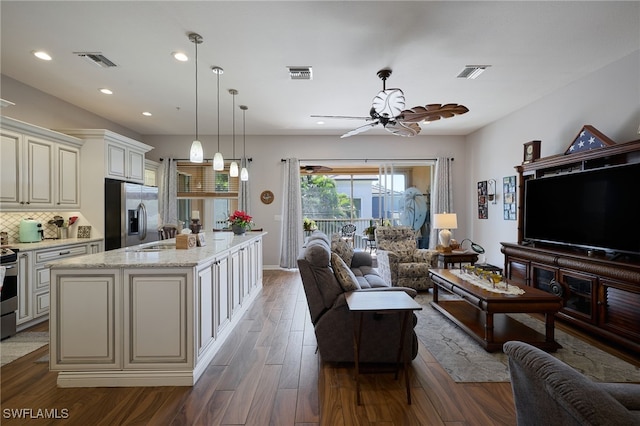 living room with ceiling fan, sink, and dark hardwood / wood-style flooring