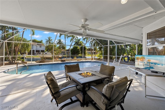 view of pool featuring ceiling fan, a patio, and glass enclosure