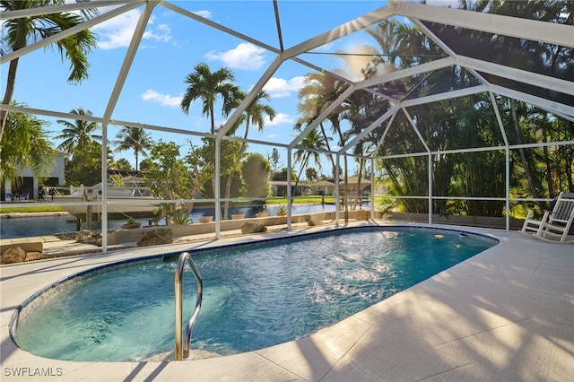 view of pool featuring a lanai, a patio area, and a water view