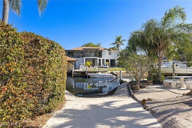 view of front of property featuring a boat dock and a water view