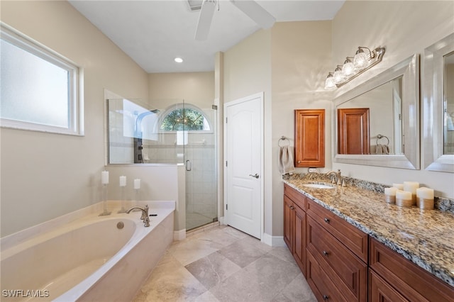 bathroom featuring ceiling fan, a garden tub, vanity, baseboards, and a stall shower