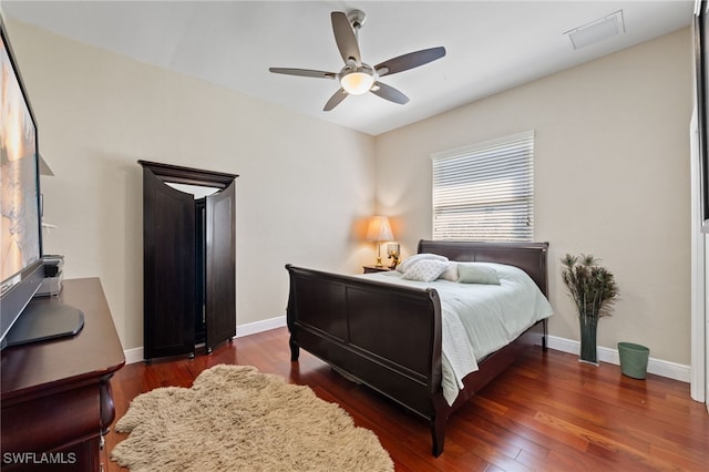 bedroom featuring ceiling fan, dark wood-type flooring, visible vents, and baseboards